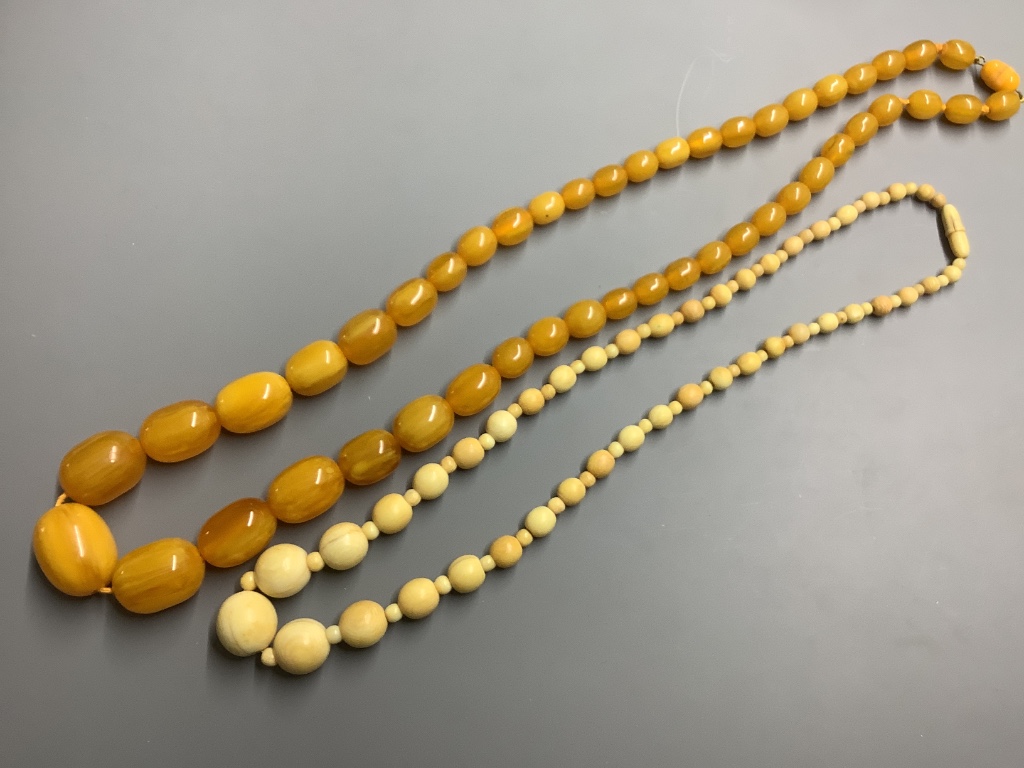 A single strand graduated cultured pearl necklace with rose cut diamond set 9 carat white gold class, 48 cm an amber necklace and three other necklaces.